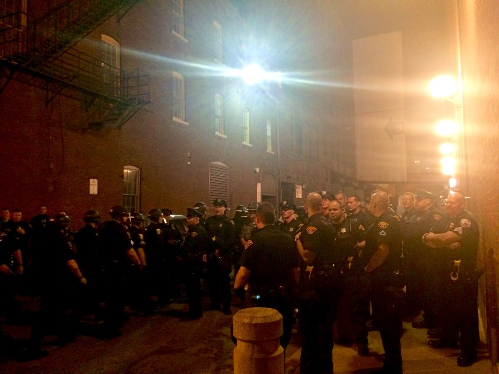 Cops block an alley to kettle protesters in Cleveland.